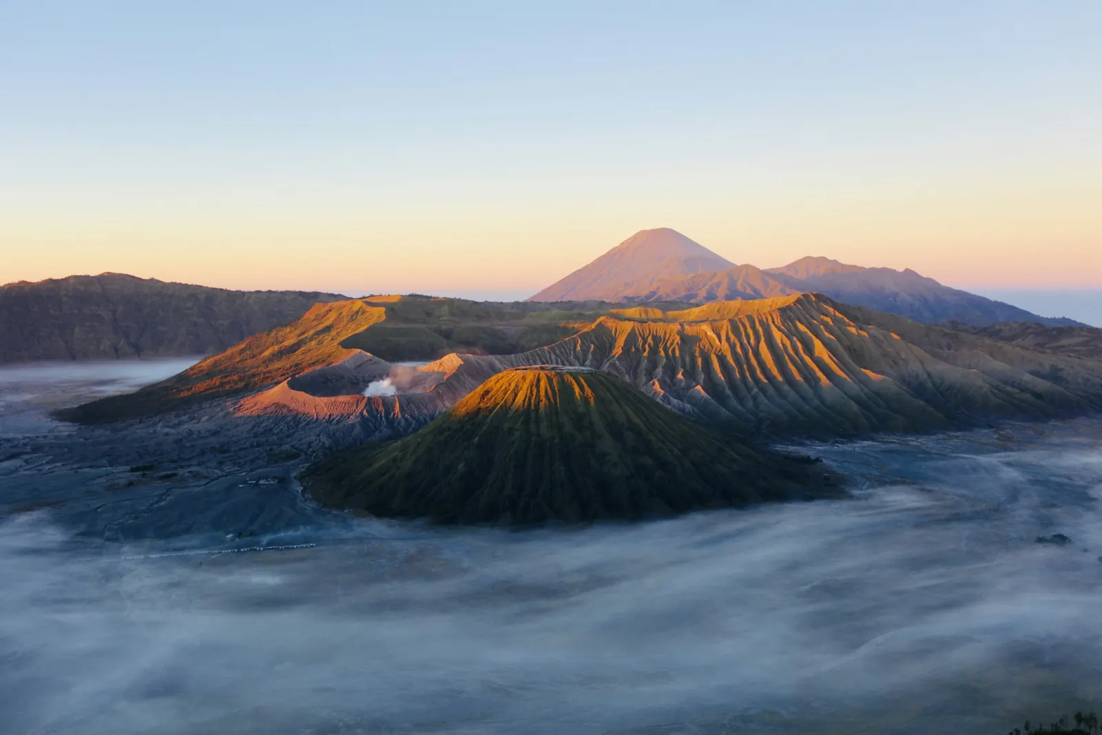 Mount Bromo and Mount Batok above a sea of mist at dawn, Mount Semeru on the horizon