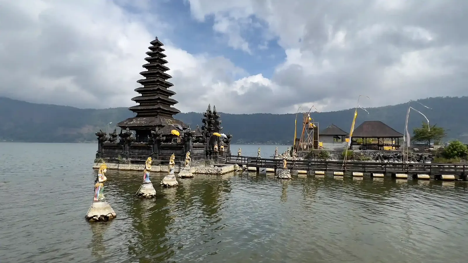A tiered Hindu temple shrine on a lake shore