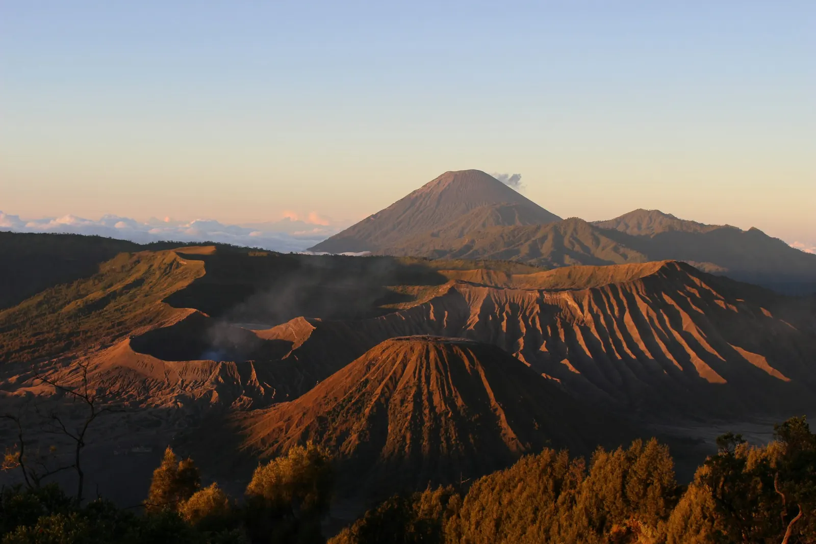 Early sun on the ridges of Mount Batok and the Bromo crater, Semeru behind