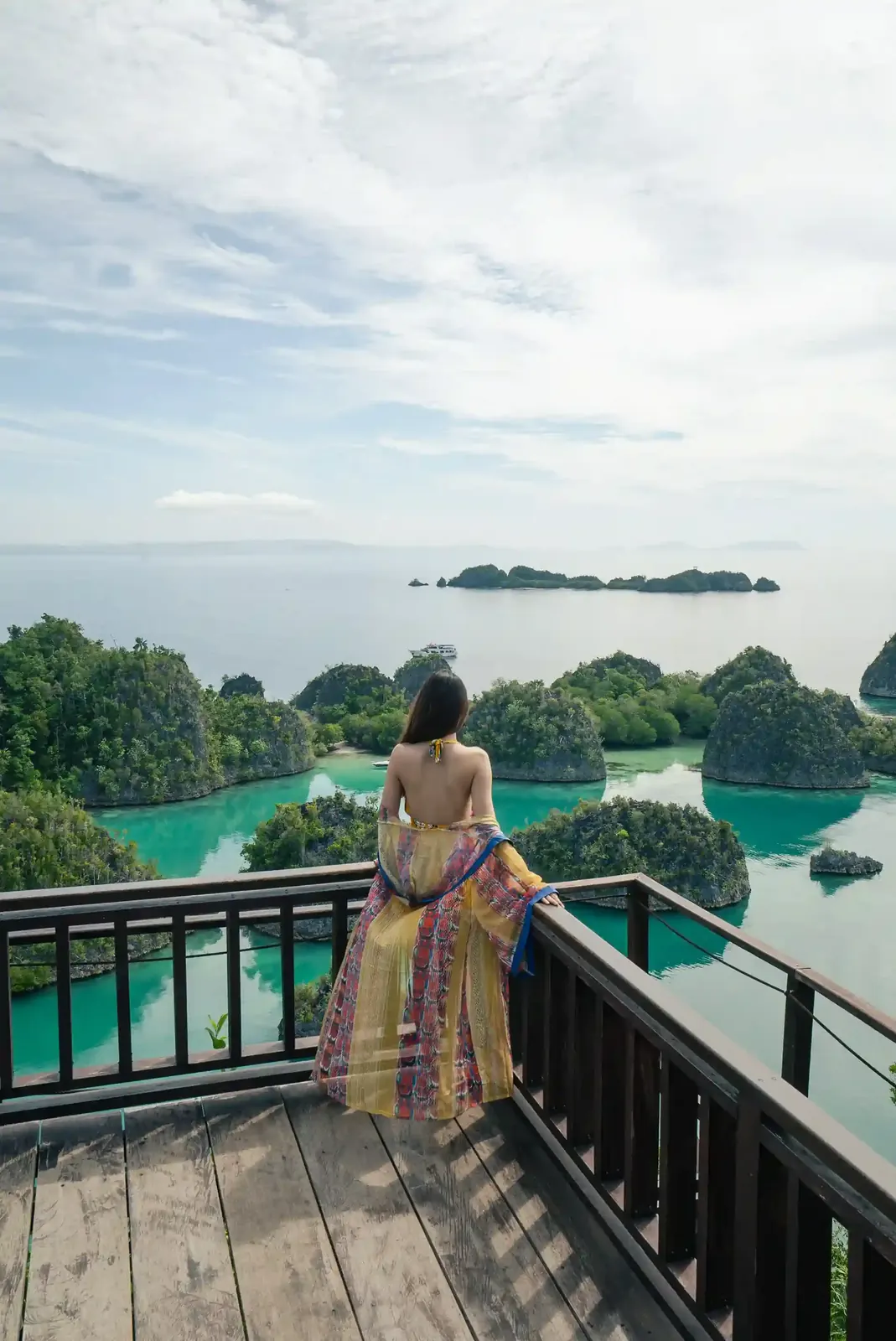 A traveller on the Piaynemo viewpoint deck in Raja Ampat